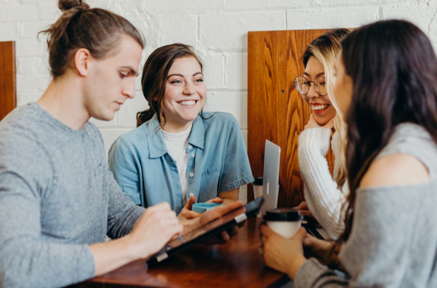 A focus group of four people discussing on a table