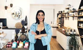 Small Australian retail business owner stands in her retail flagship store.