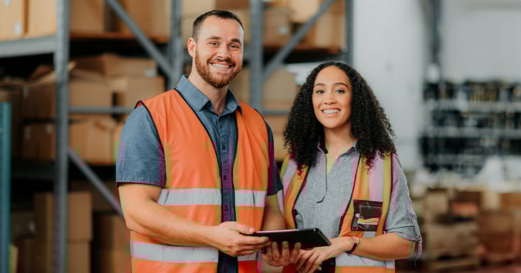 Happy man and woman confident with shipping inside a warehouse