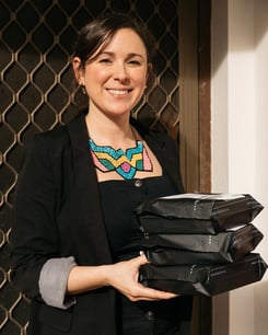 Mayte Saloni holding oleu life parcels for shipping with sendle