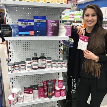 Pharmacy Junction employee showing products