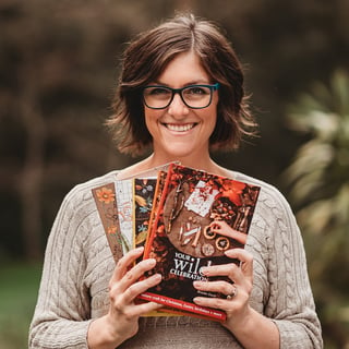 your wild books owner Brooke Davis holding books