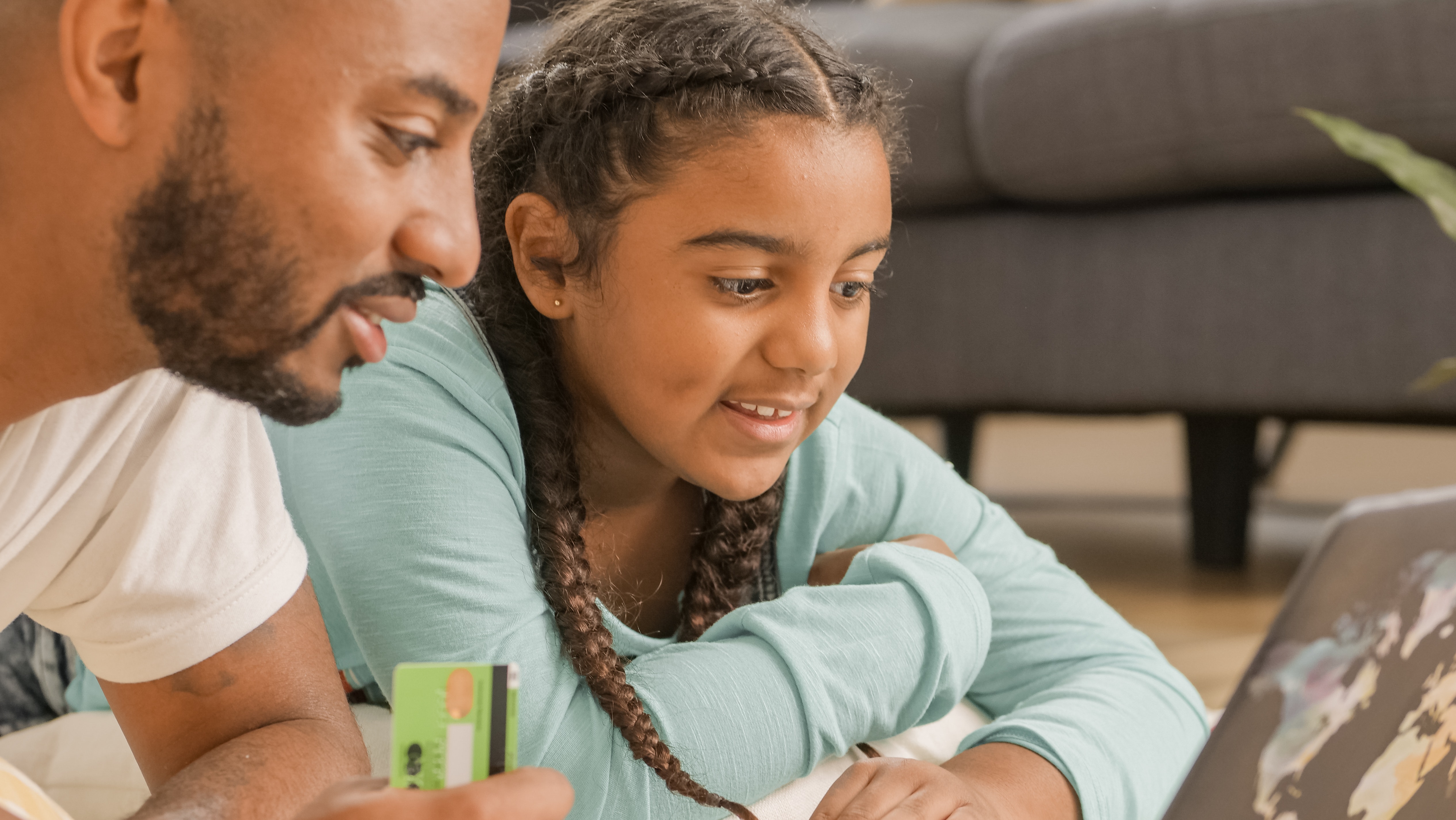 sendle image of african american father and daughter online shopping using card