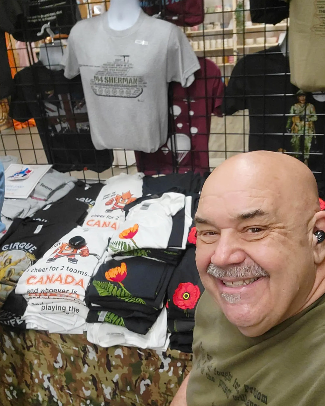 founder of d day wear posing with shirts