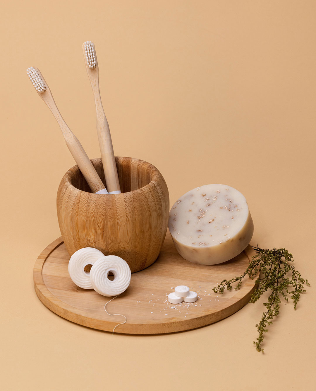 Bamboo toothbrush kit along side floss and soap that are nature friendly