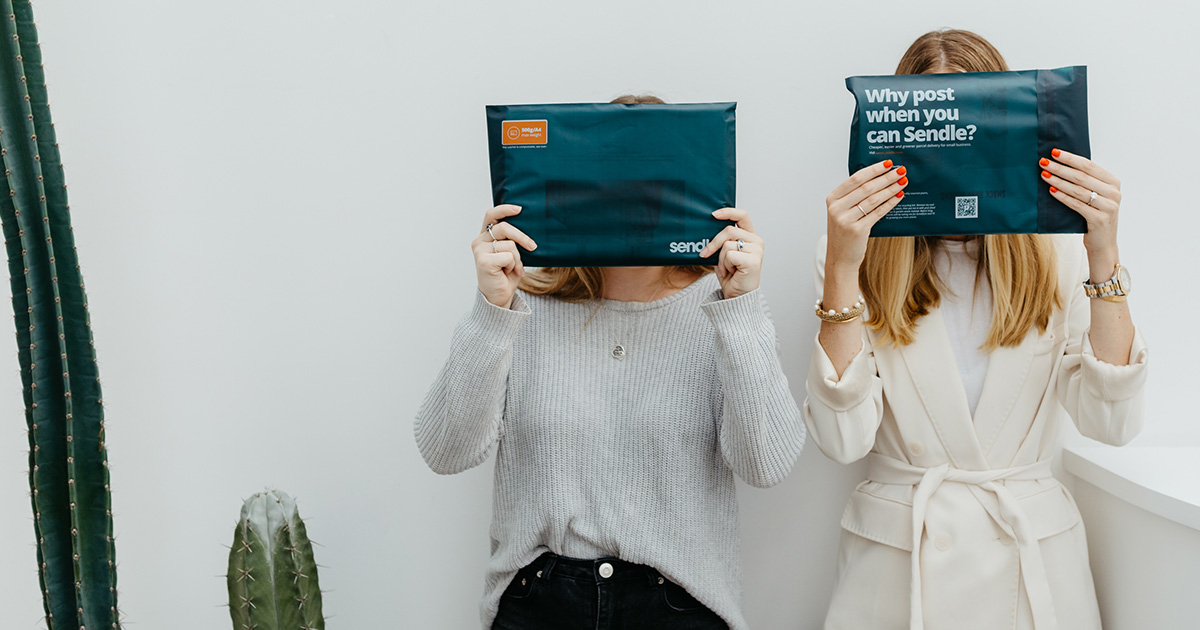 customers covering their faces with compostable satchels or mailers