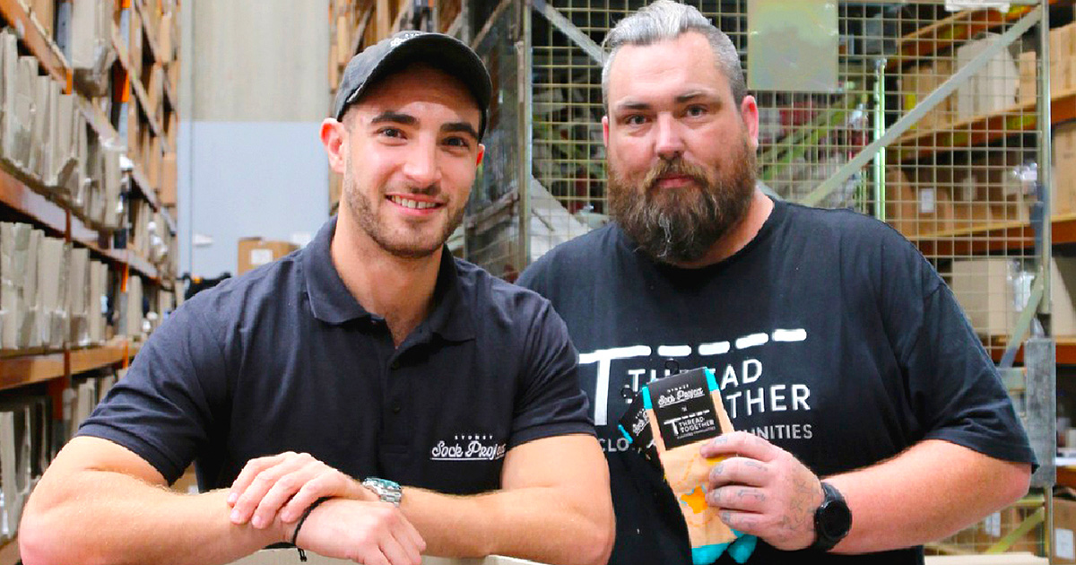 two people at a warehouse for sydney sock project