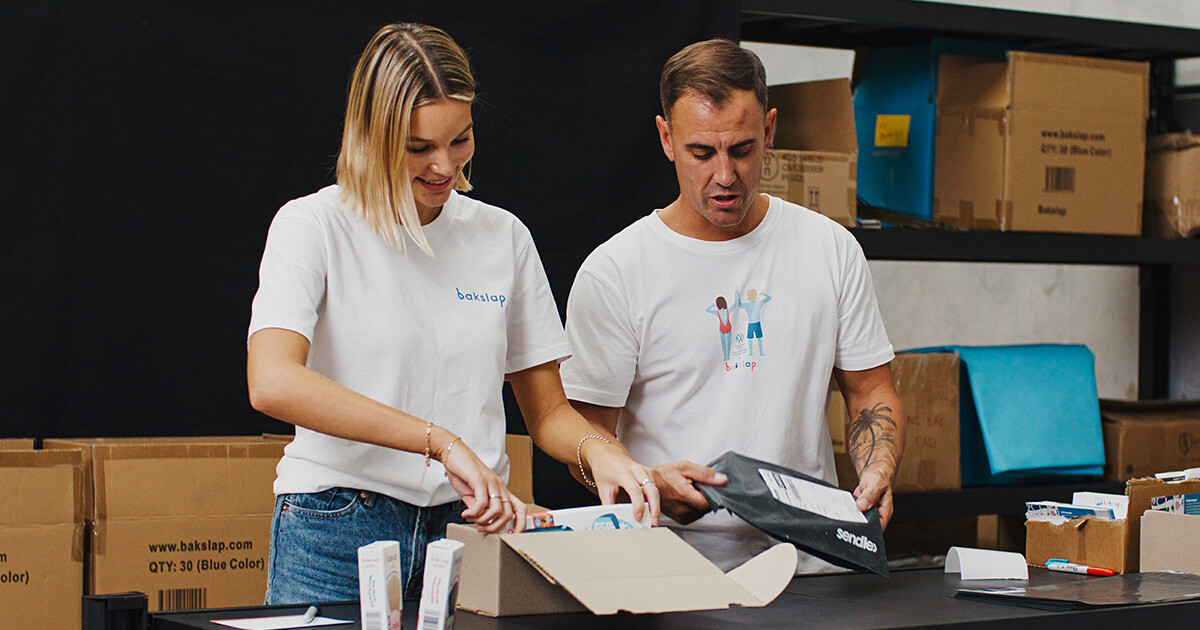 woman and man working packing bakslap products in boxes and 250g satchels