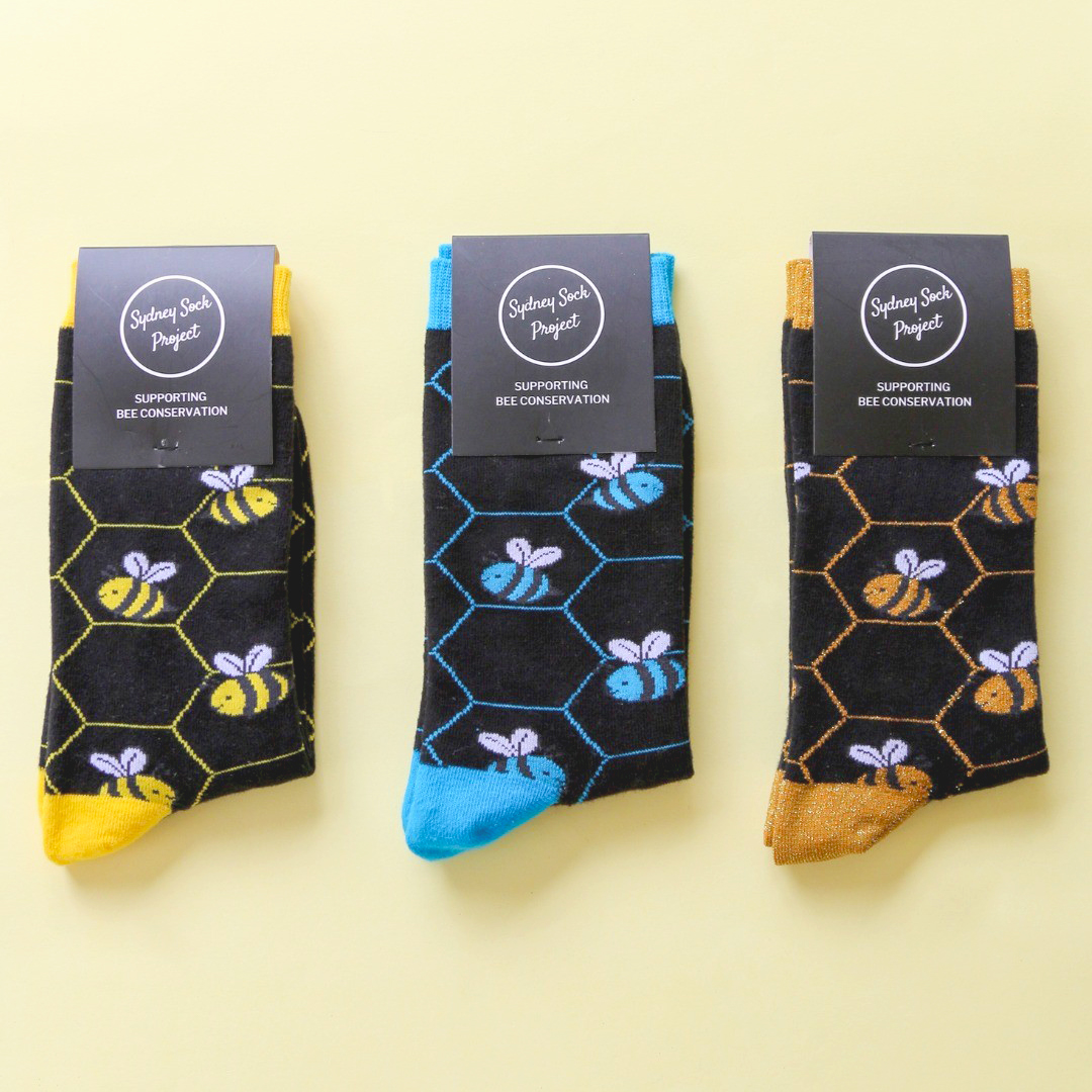 sydney-sock-project-product-shot-three-different-color-pairs-save-the-bees-socks-flat-lay