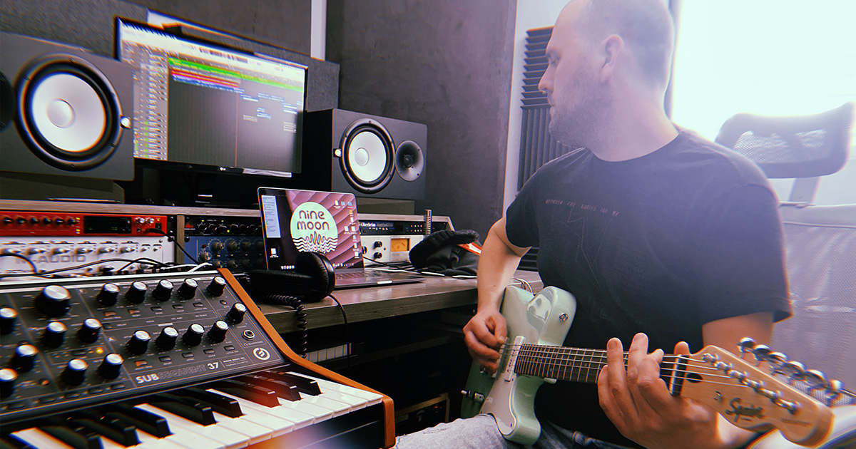 person in a studio with a guitar