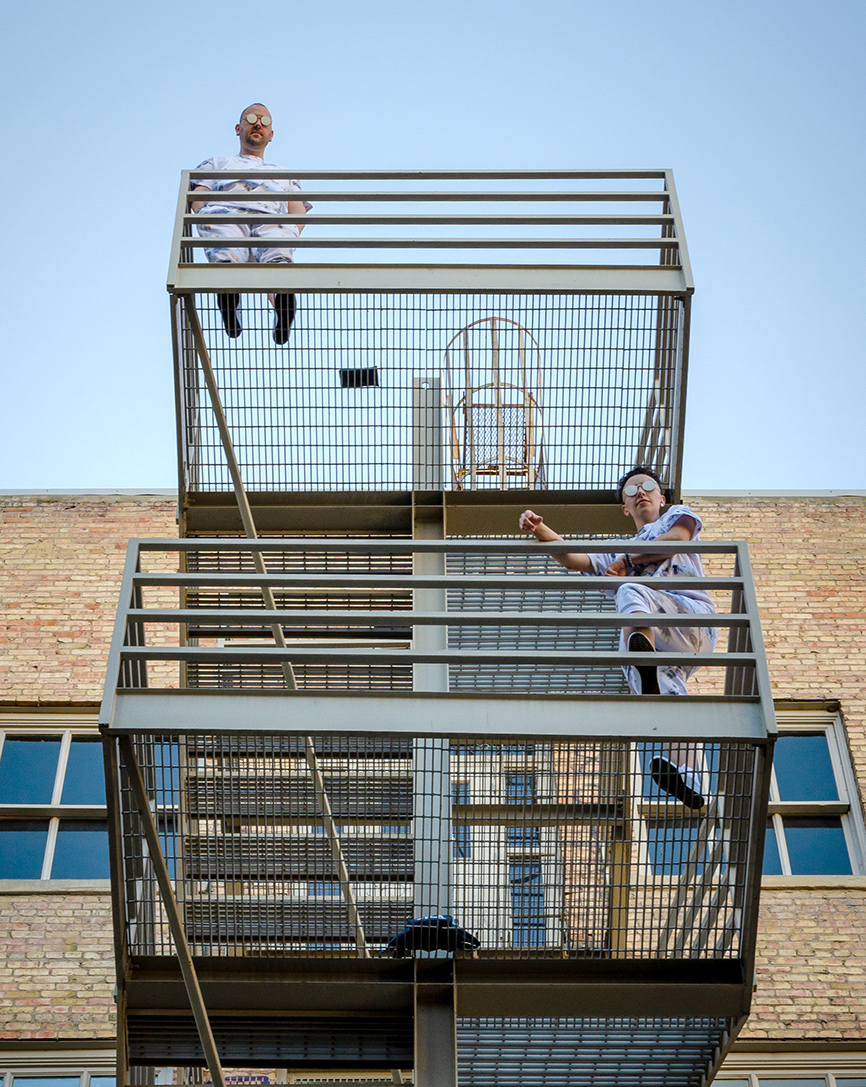 two people posing outdoor on a staircase