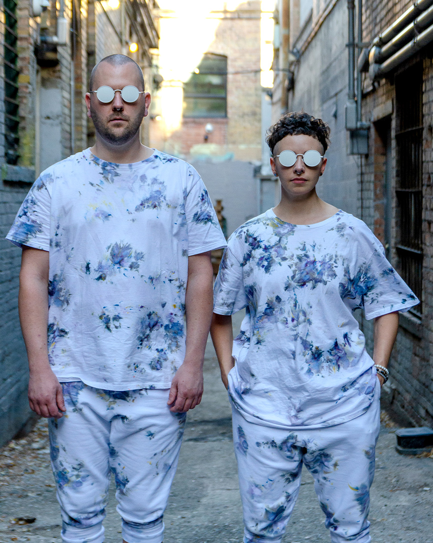 two people wearing matching outfits with glasses