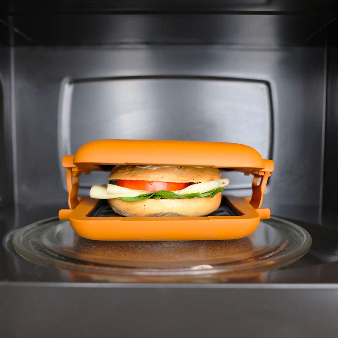 person making toasted bread on a microwave square grill