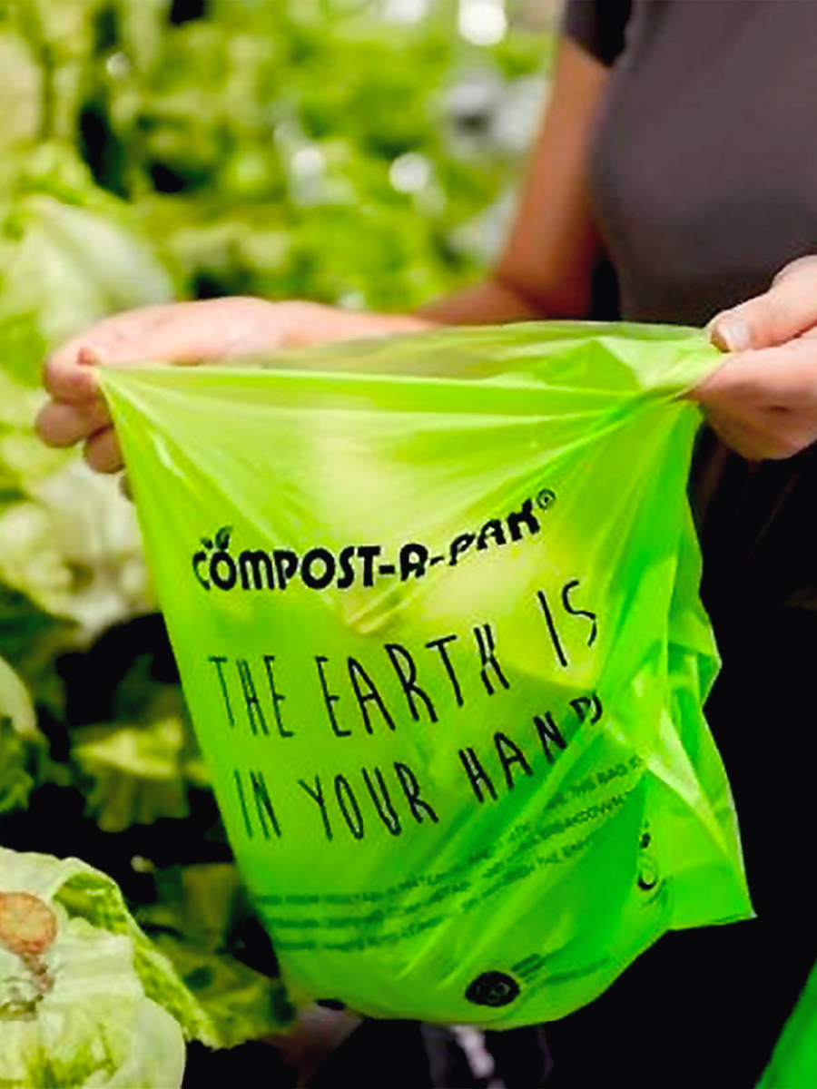 a compostable scrap bag from Compost-A-Pak being usedd by a customer
