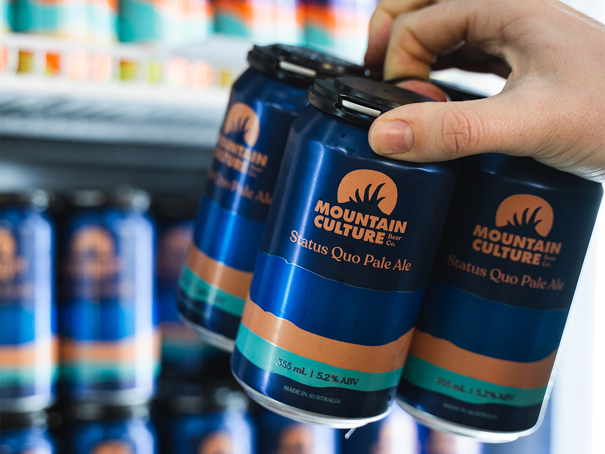 bundle can of beer being pulled out of refrigerator