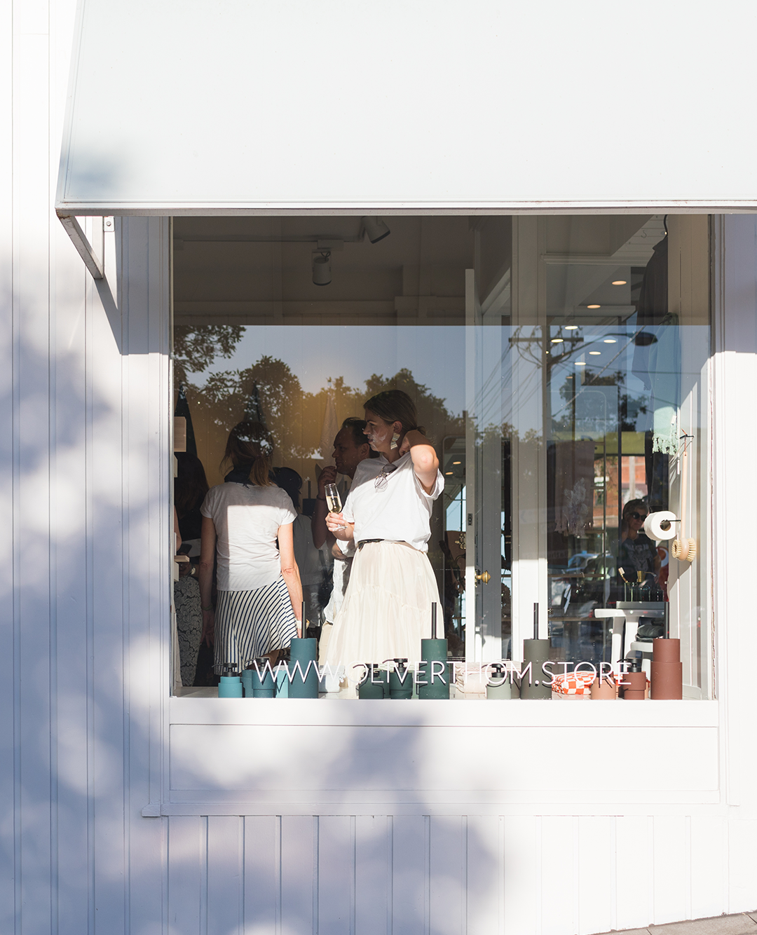 crowd of people seen from outside the shop window