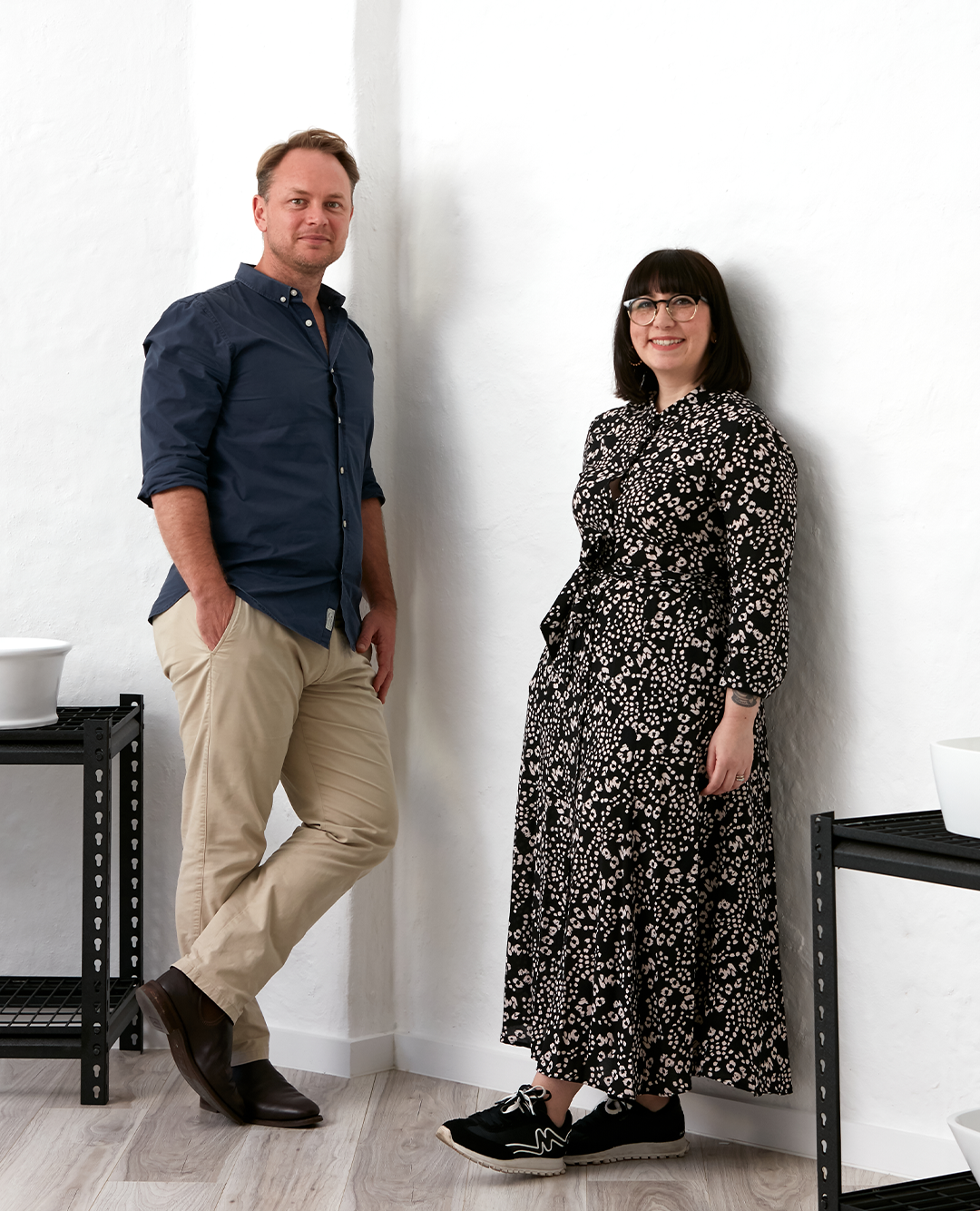 man and woman standing smiling with white background