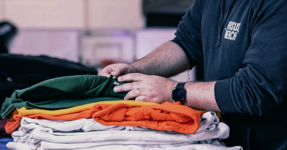 person folding shirts