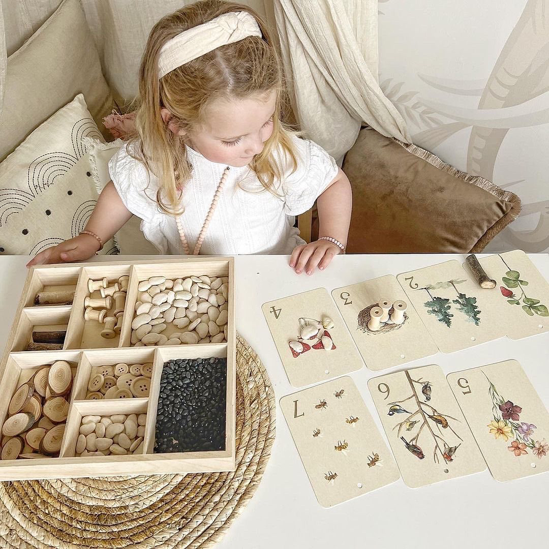 little girl playing with wooden toy