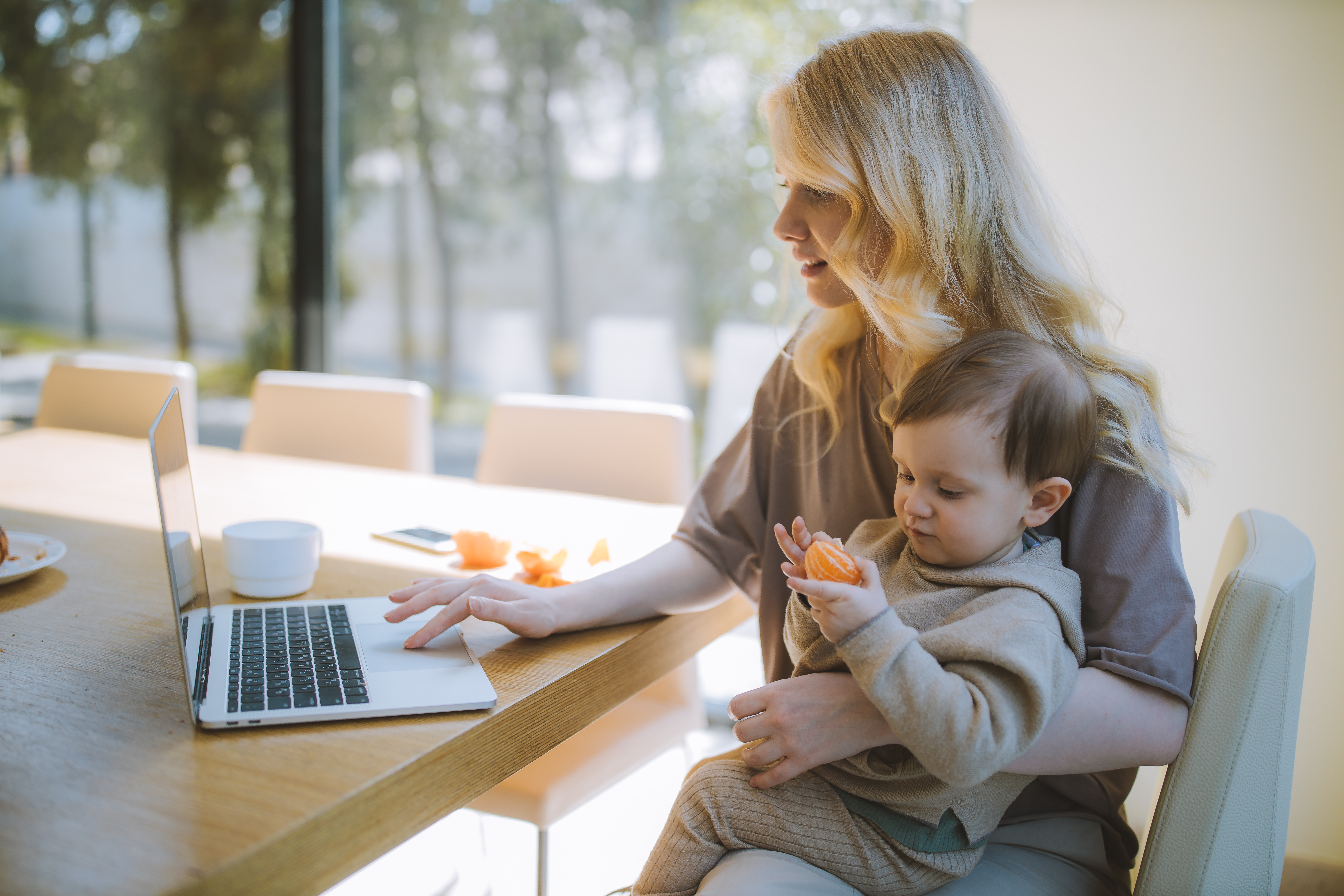 sendle image of a blonde working mom with her baby boy working from home